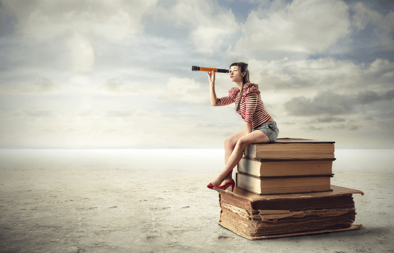woman sitting on books with a telescope for clarity in the next chapter
