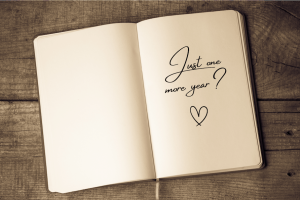 Book with words 'Just one more year' for those considering the right time to retire